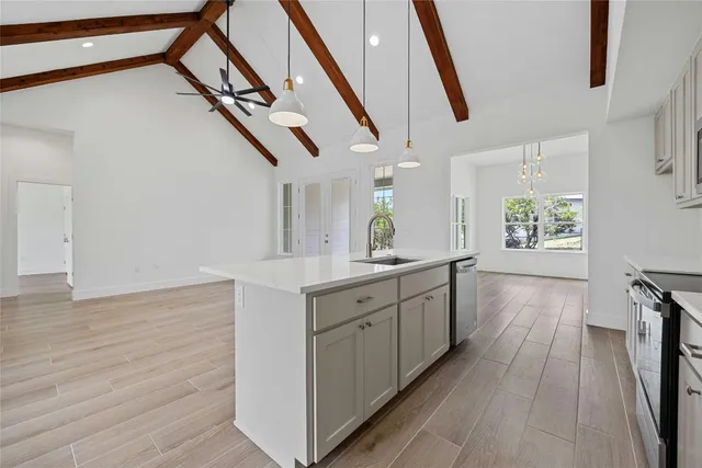 a view of a hallway with wooden floors and stairs