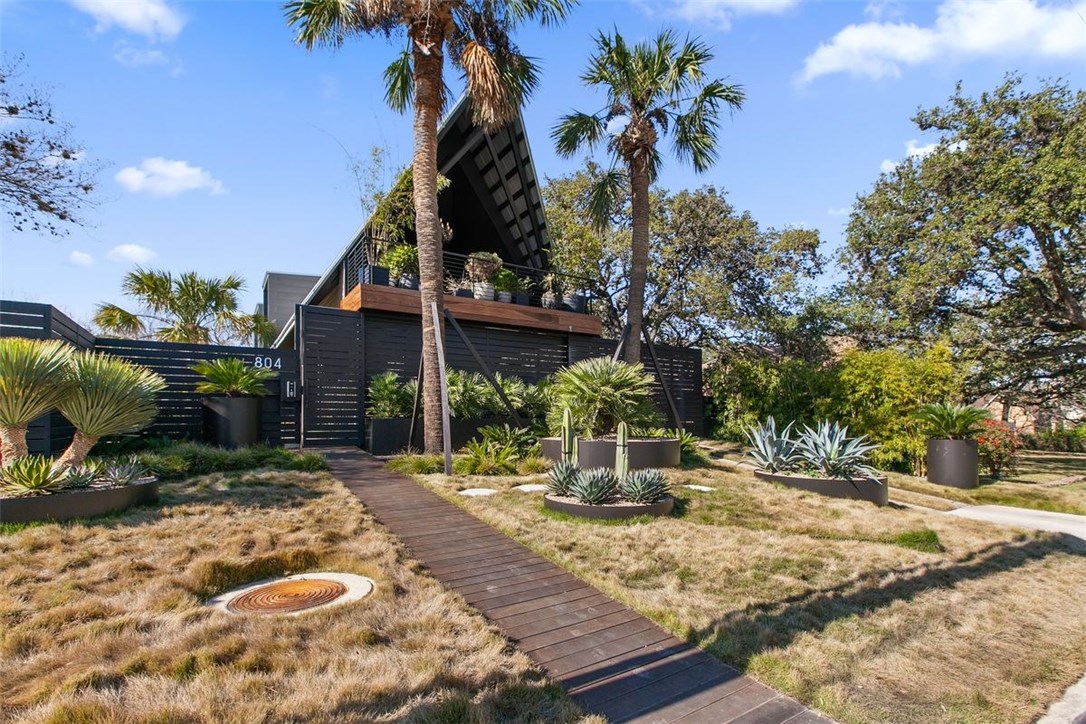 a view of a house with a tree in a yard