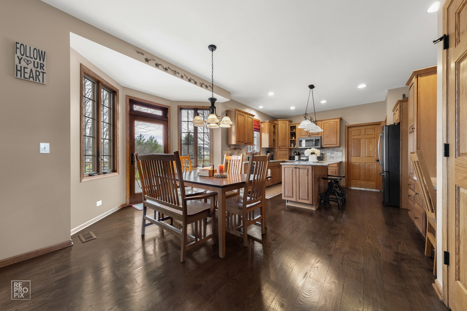 355 Meadow View Burlington, IL 60109 - Photo 7 of 37 a view of a kitchen with dining table and chairs