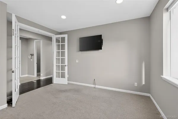 an empty room with windows and closet