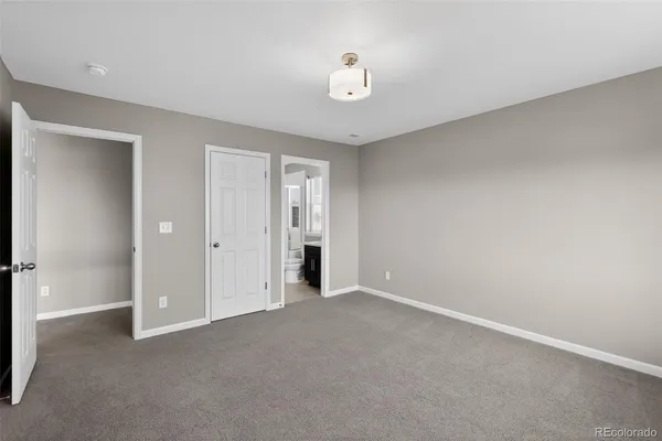 a view of an empty room with a closet