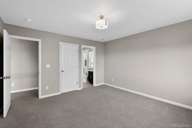 a view of an empty room with a closet