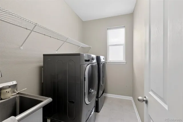 a view of a bathroom with a sink and washing machine