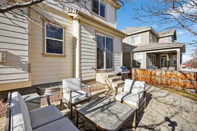 a view of a patio with couches table and chairs and potted plants