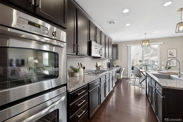 a kitchen with lots of counter top space and wooden floor