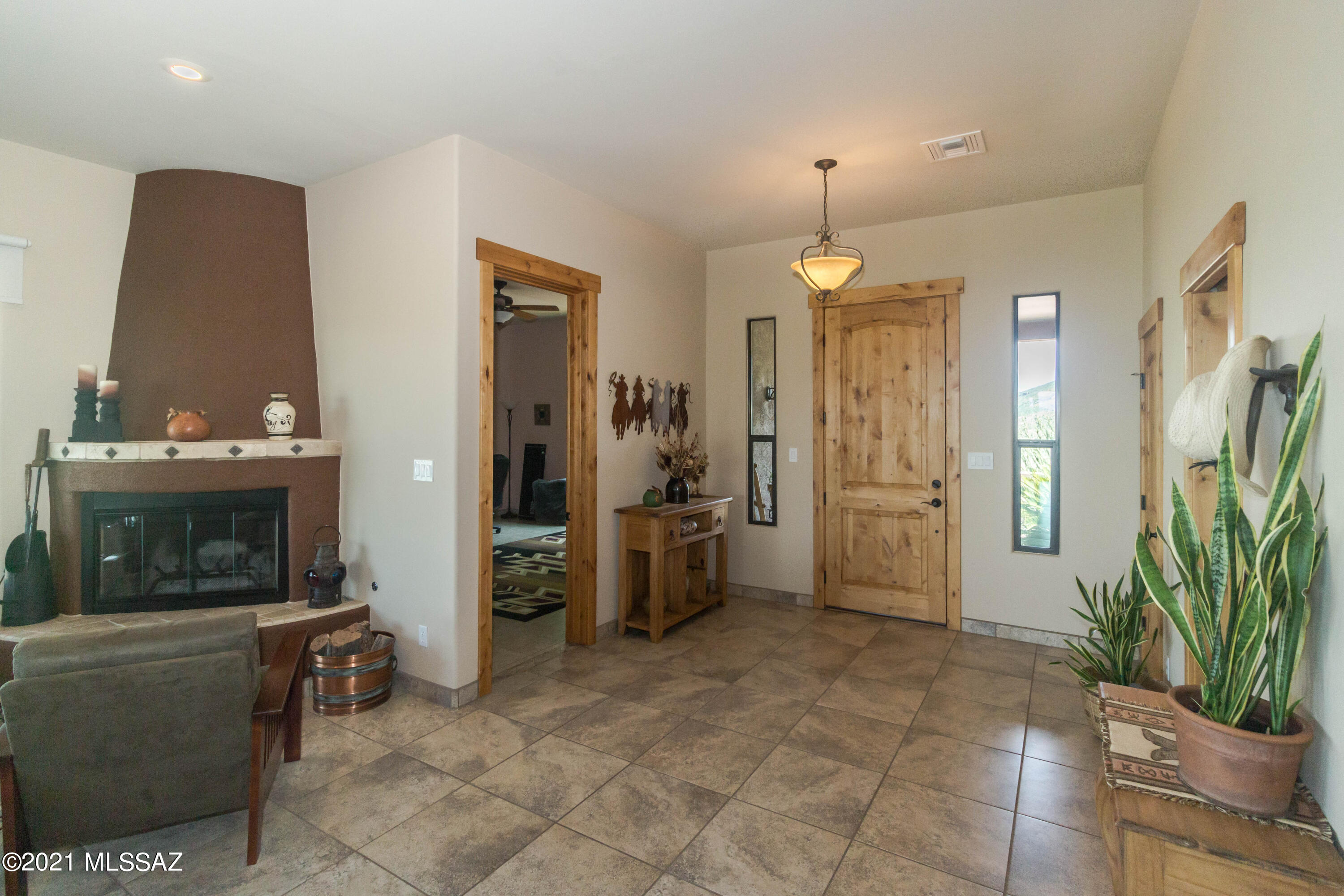 1567 Camino Esturion Rio Rico, AZ 85648 - Photo 15 of 41 a living room with furniture a fireplace and a potted plant