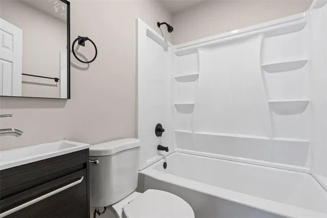 a bathroom with a toilet a sink and a bathtub