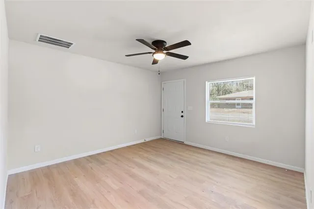 a view of a room with a ceiling fan and a window