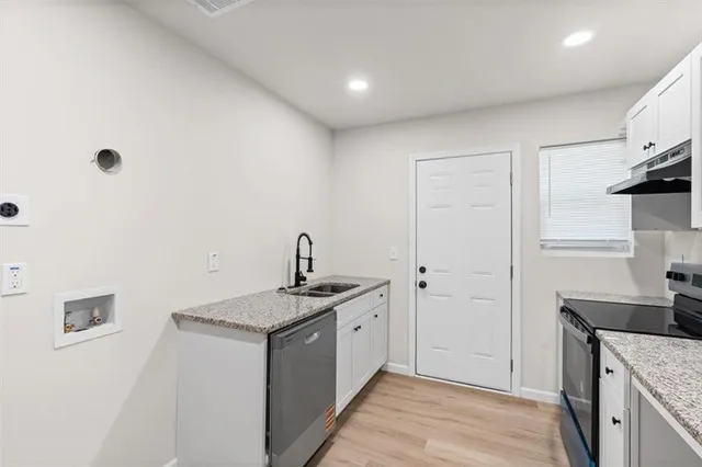 a kitchen with a sink stove and refrigerator