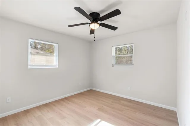 a view of empty room with wooden floor