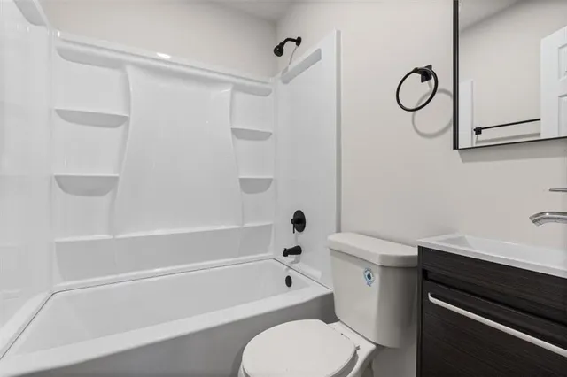 a bathroom with a toilet a sink and a bathtub