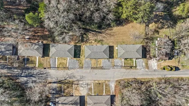 a buildings covered with tall trees
