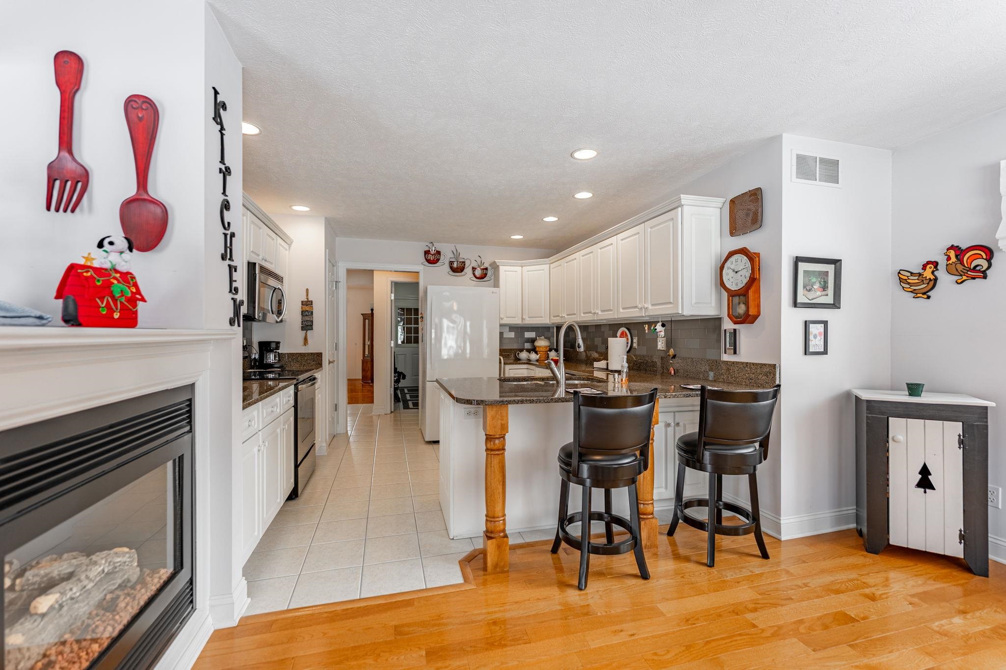 225 Secretariat's Way Belvidere, IL 61008 - Photo 11 of 41 a kitchen with stainless steel appliances granite countertop a refrigerator and microwave