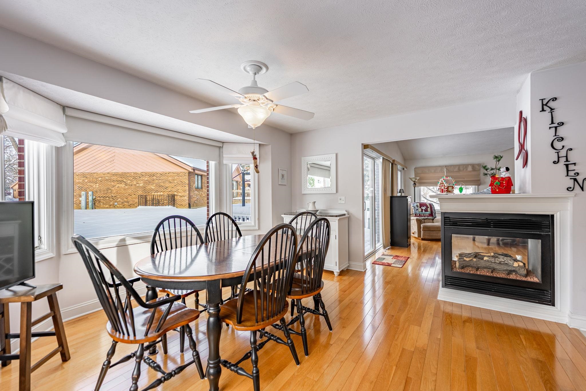 225 Secretariat's Way Belvidere, IL 61008 - Photo 12 of 41 a dining room with furniture a fireplace a rug and a chandelier