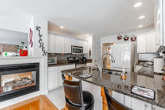 a kitchen with refrigerator and cabinets