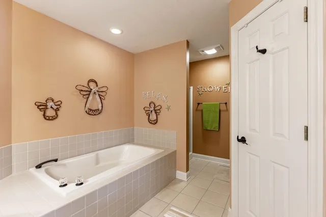 a bathroom with a bathtub and shower