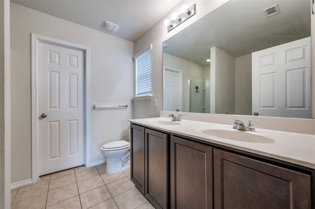1420 Rivers Creek Lane Little Elm, TX 75068 - Photo 19 of 25 a bathroom with a sink a toilet and a mirror