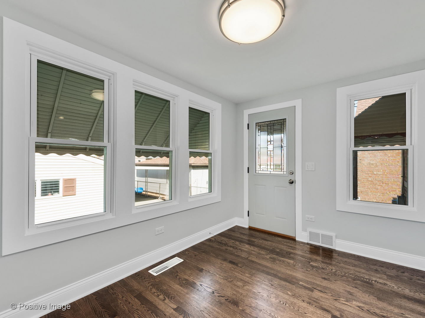 2232 Forest Avenue North Riverside, IL 60546 - Photo 2 of 17 an empty room with wooden floor and windows