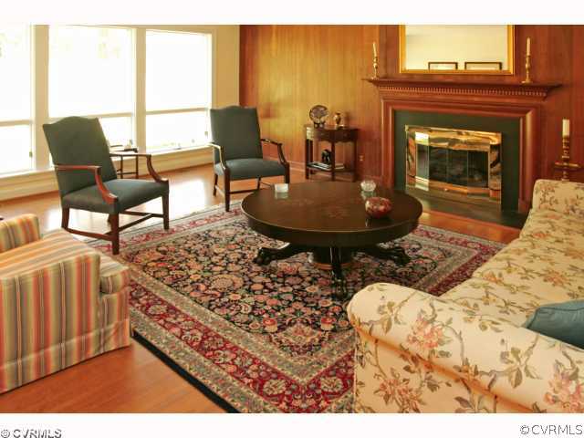 4544 Arrowhead Road Richmond, VA 23235 - Photo 3 of 12 a living room with furniture a fireplace and a table