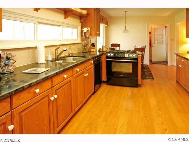 4544 Arrowhead Road Richmond, VA 23235 - Photo 6 of 12 a kitchen with stainless steel appliances kitchen island granite countertop a sink and cabinets