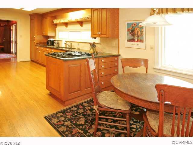 4544 Arrowhead Road Richmond, VA 23235 - Photo 7 of 12 a kitchen with stainless steel appliances granite countertop a stove a sink and a microwave