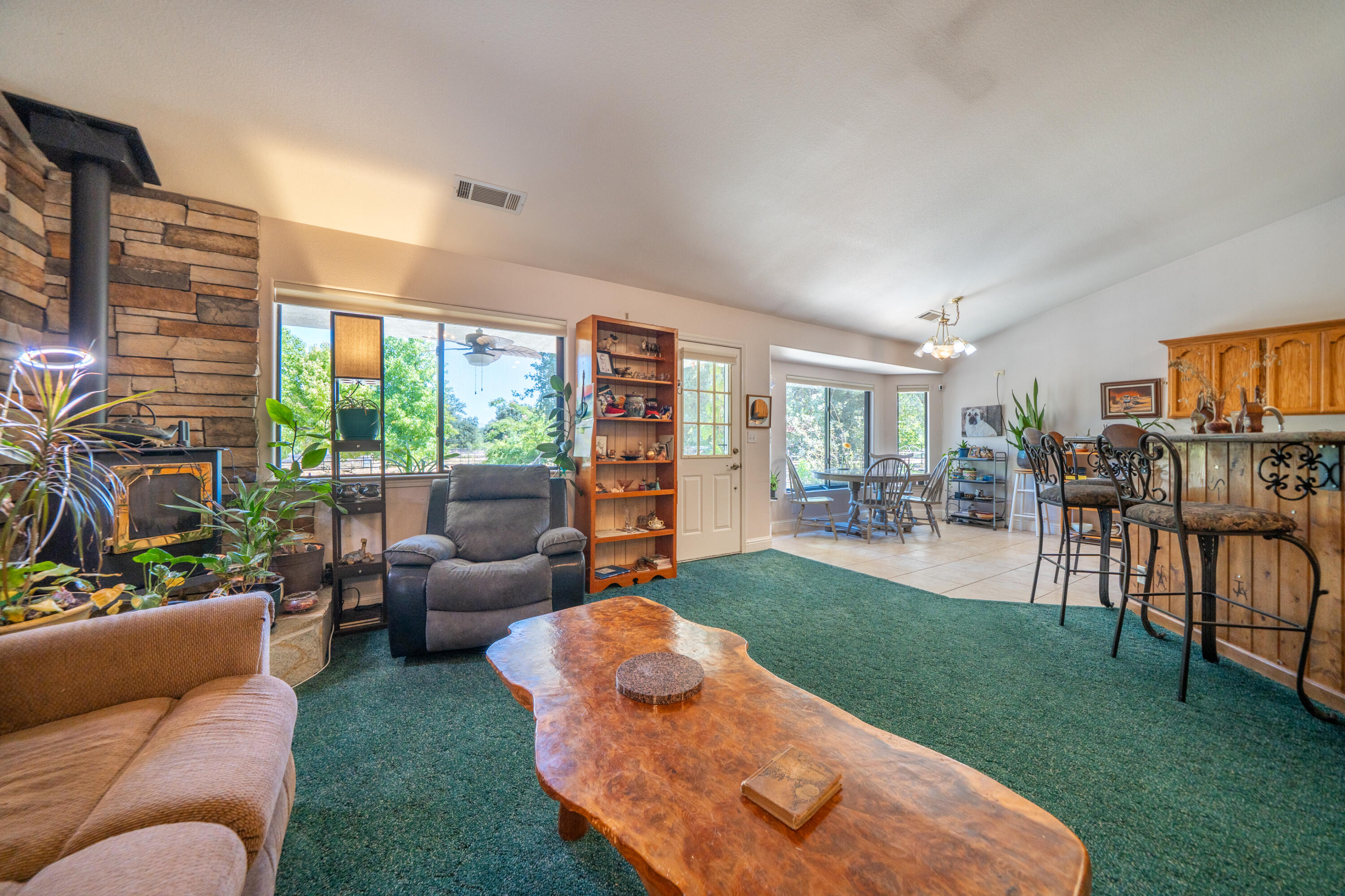 8533 Maynard Road Palo Cedro, CA 96073 - Photo 12 of 100 a view of a patio with couches chairs dining table and chairs potted plants with sky view