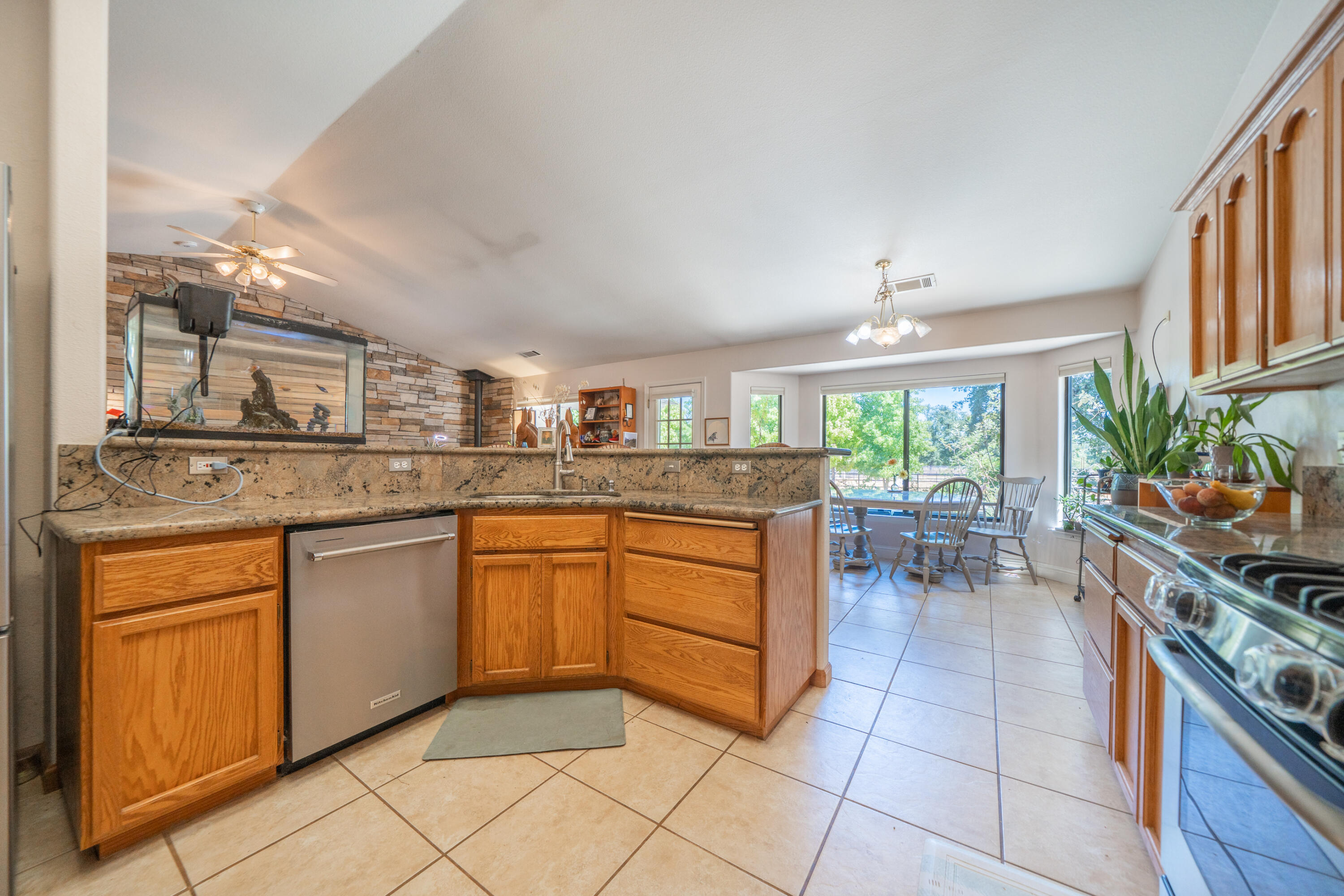 8533 Maynard Road Palo Cedro, CA 96073 - Photo 17 of 100 a kitchen with stainless steel appliances granite countertop a stove a sink and a microwave