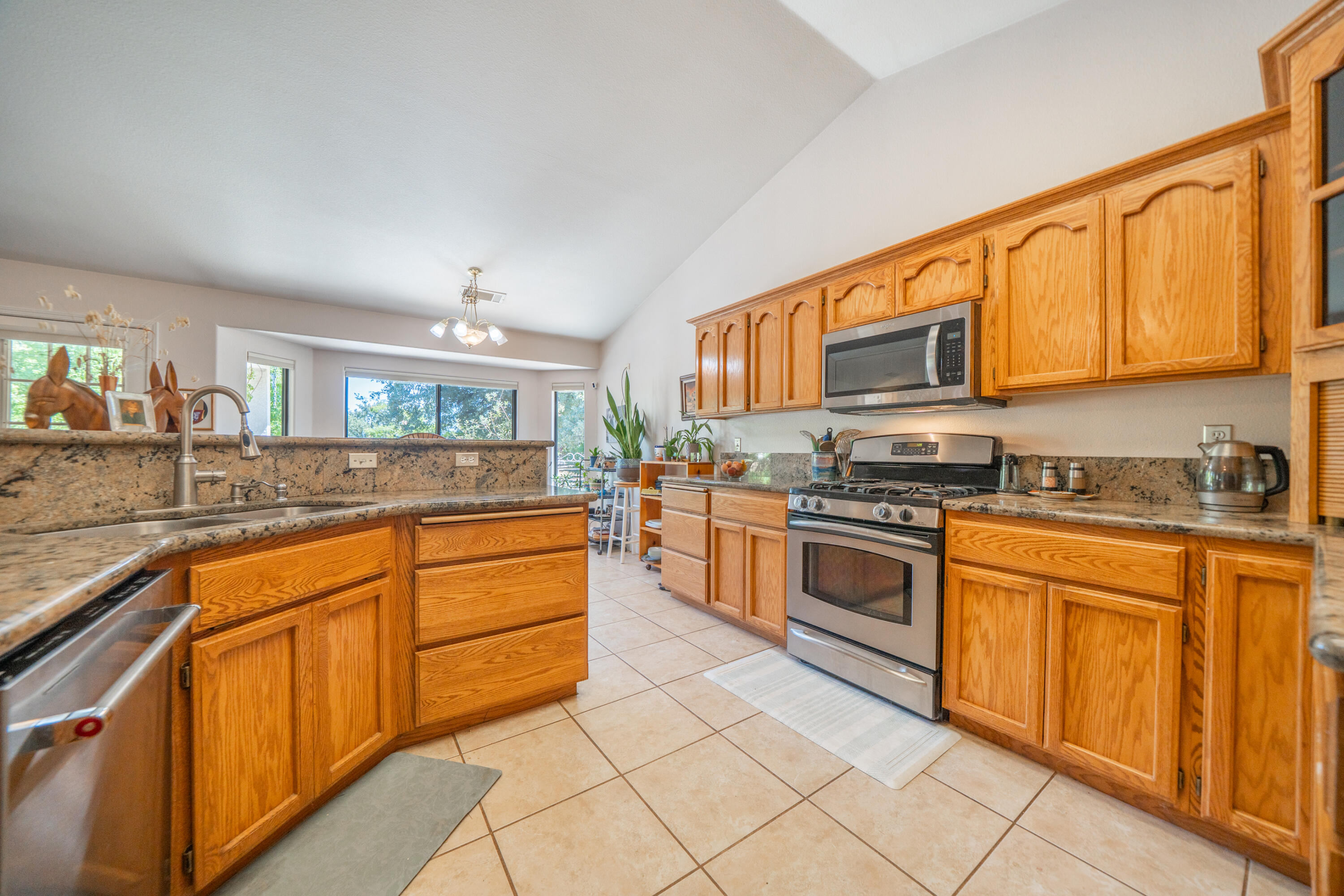 8533 Maynard Road Palo Cedro, CA 96073 - Photo 18 of 100 a kitchen with stainless steel appliances granite countertop a stove a sink and a microwave