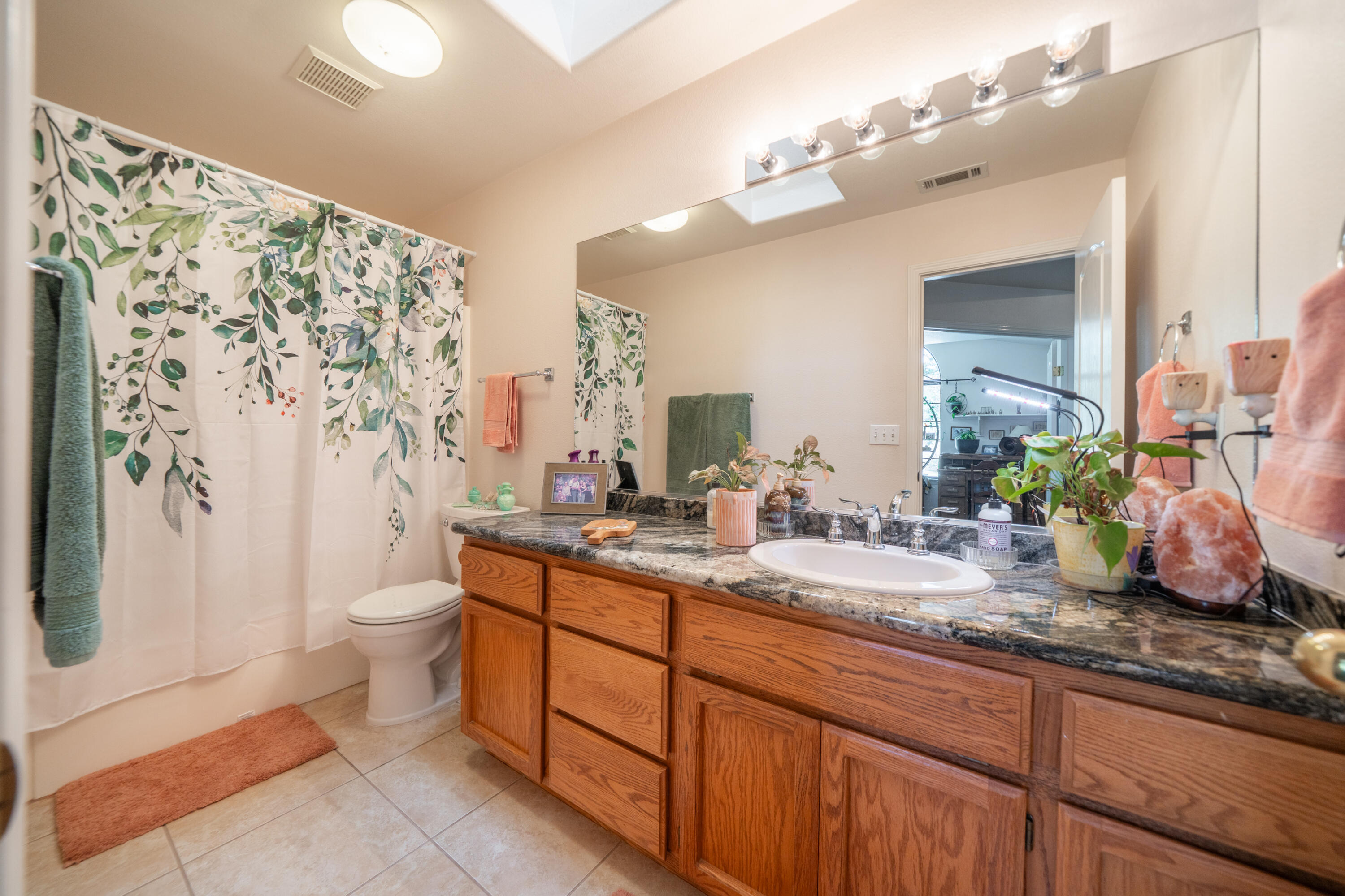 8533 Maynard Road Palo Cedro, CA 96073 - Photo 29 of 100 a bathroom with double vanity sink a toilet a mirror and shower