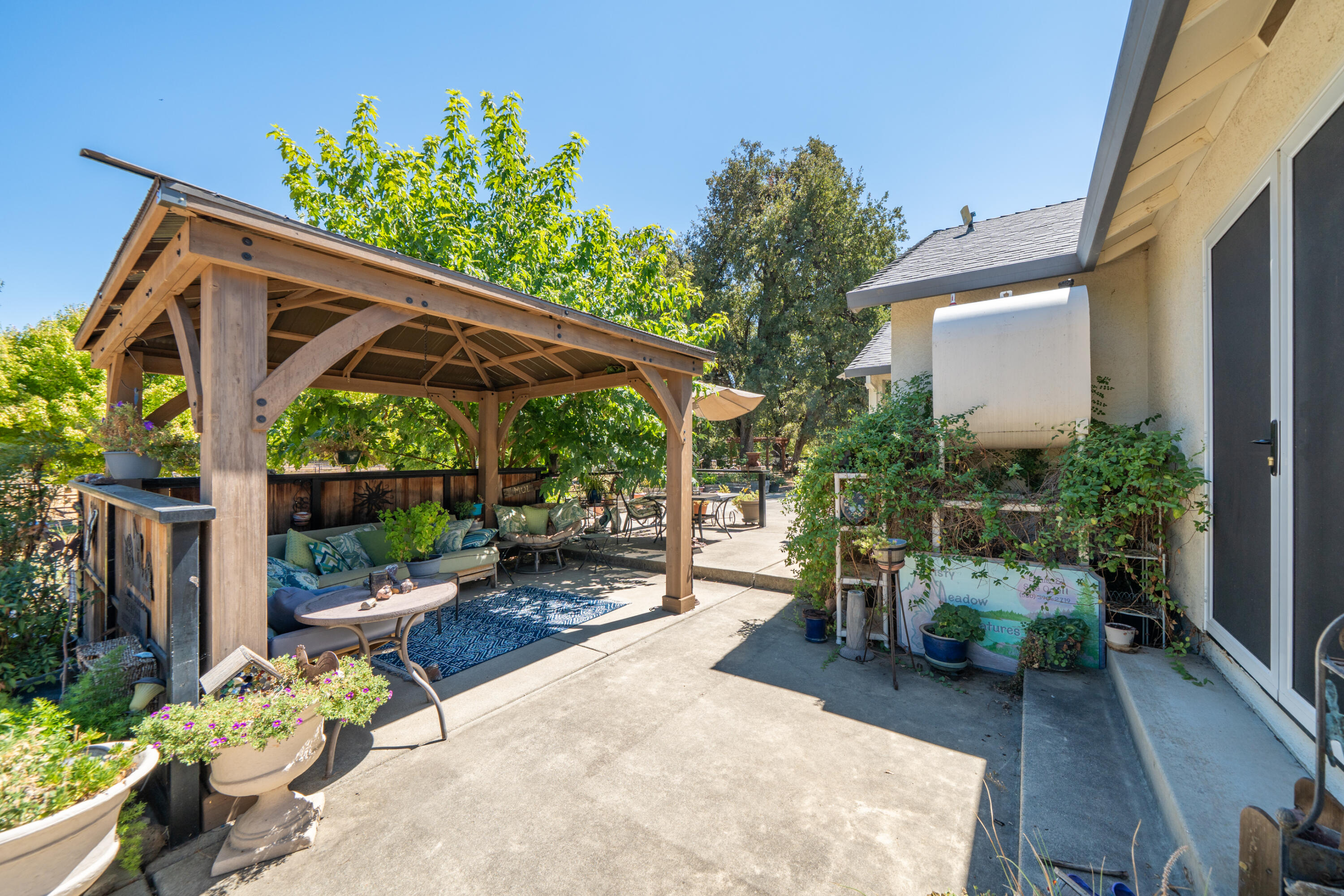 8533 Maynard Road Palo Cedro, CA 96073 - Photo 39 of 100 a view of a chair and table in backyard of the house