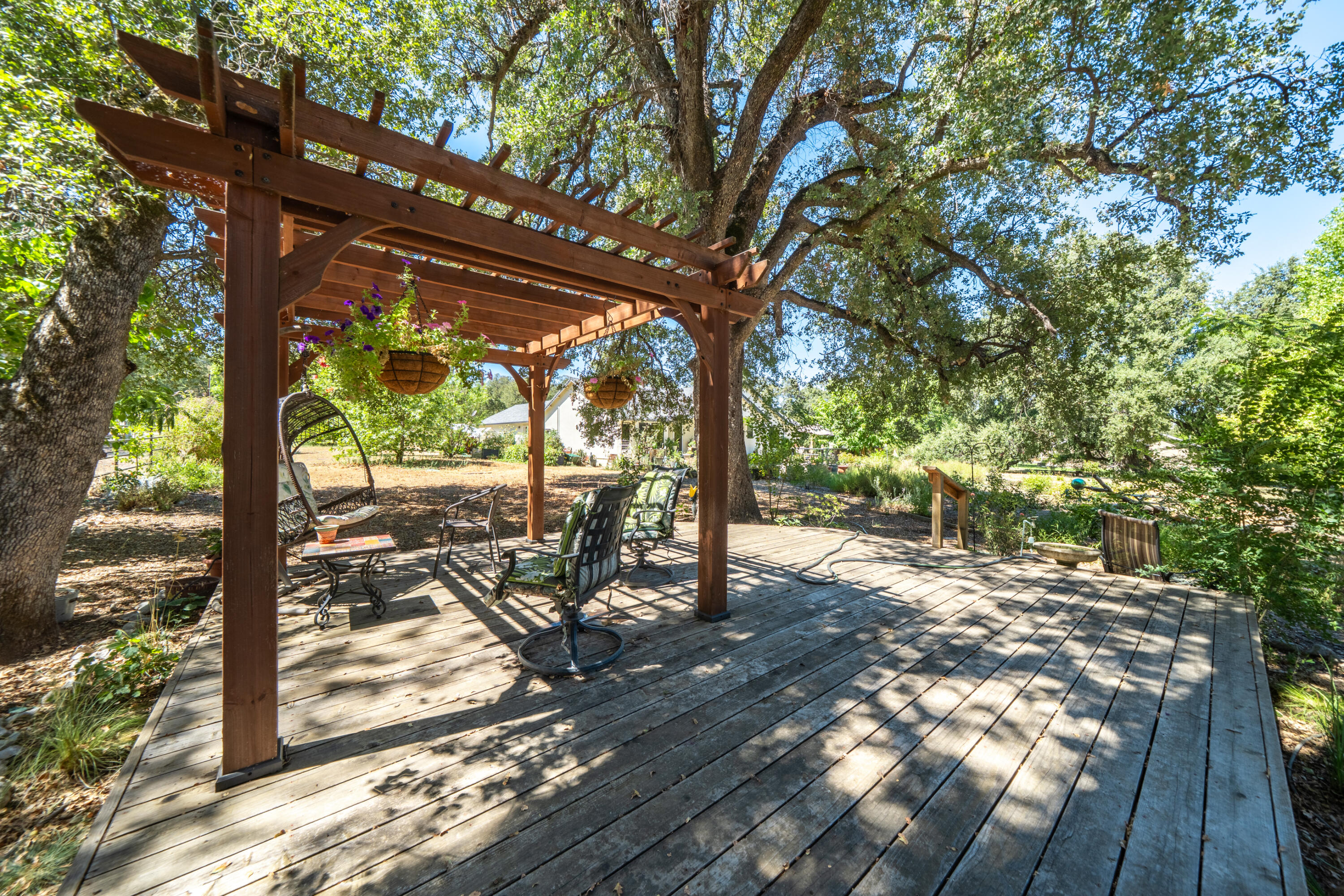 8533 Maynard Road Palo Cedro, CA 96073 - Photo 52 of 100 a view of a wooden deck next to a yard