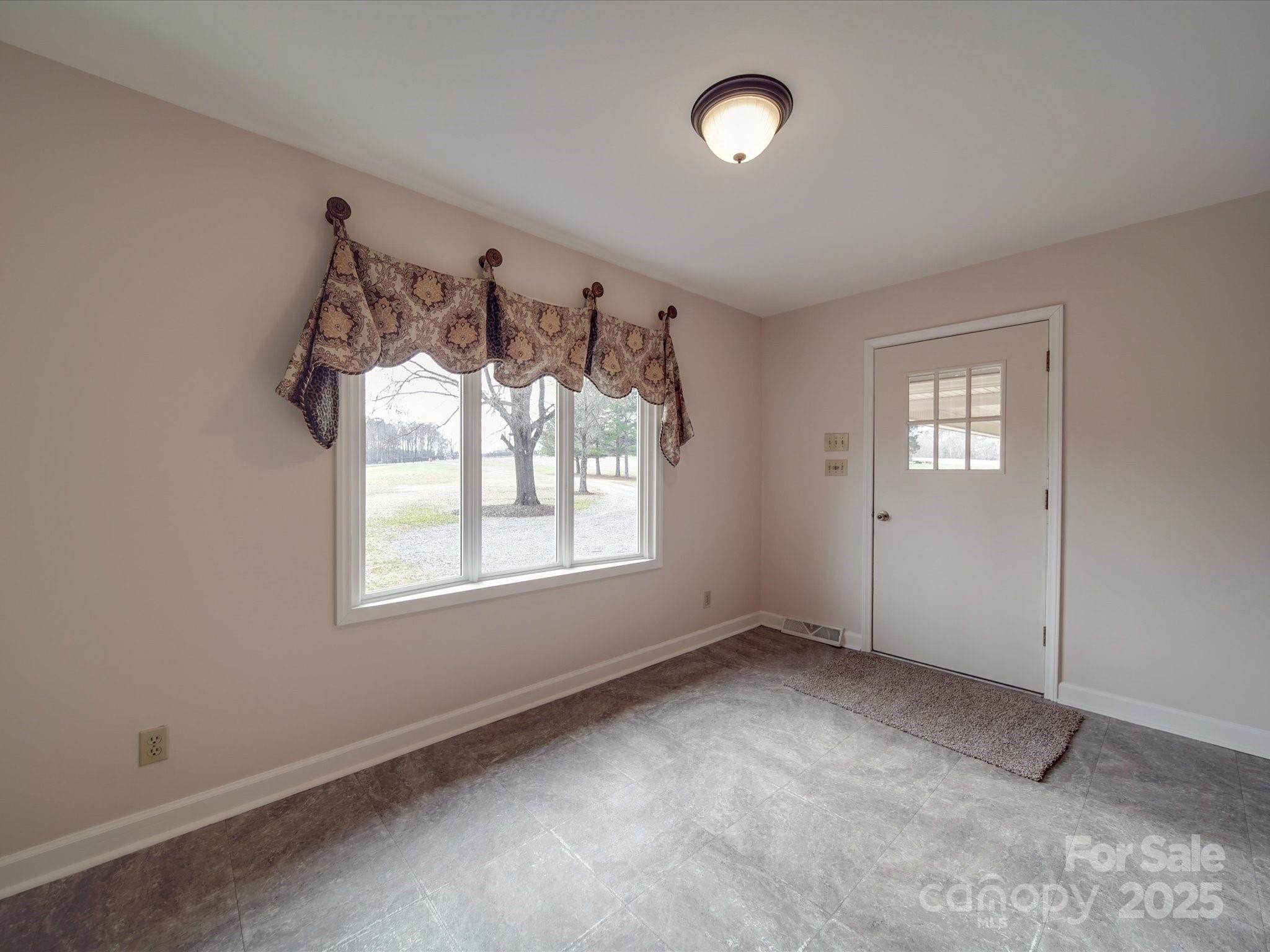 1515 Hasty Road Marshville, NC 28103 - Photo 25 of 40 an empty room with windows and ceiling fan