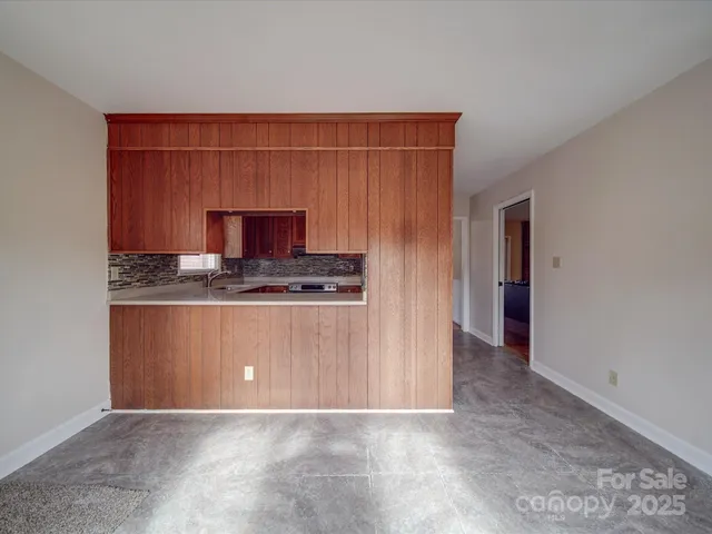 a utility room with sink dryer and cabinets
