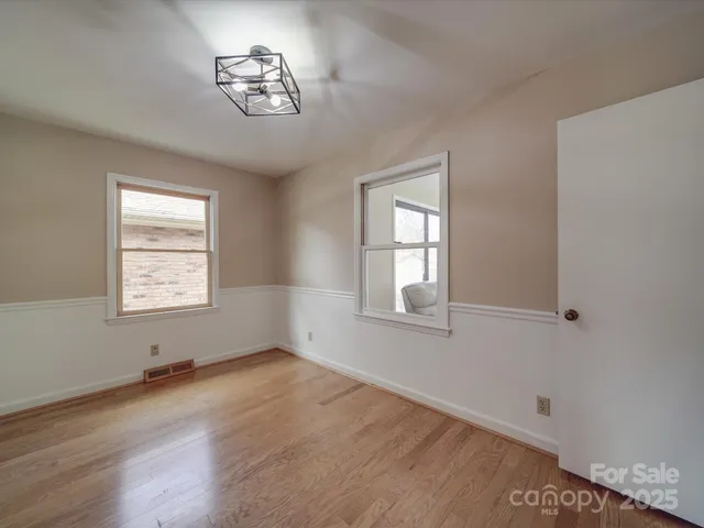 a living room with furniture and a ceiling fan