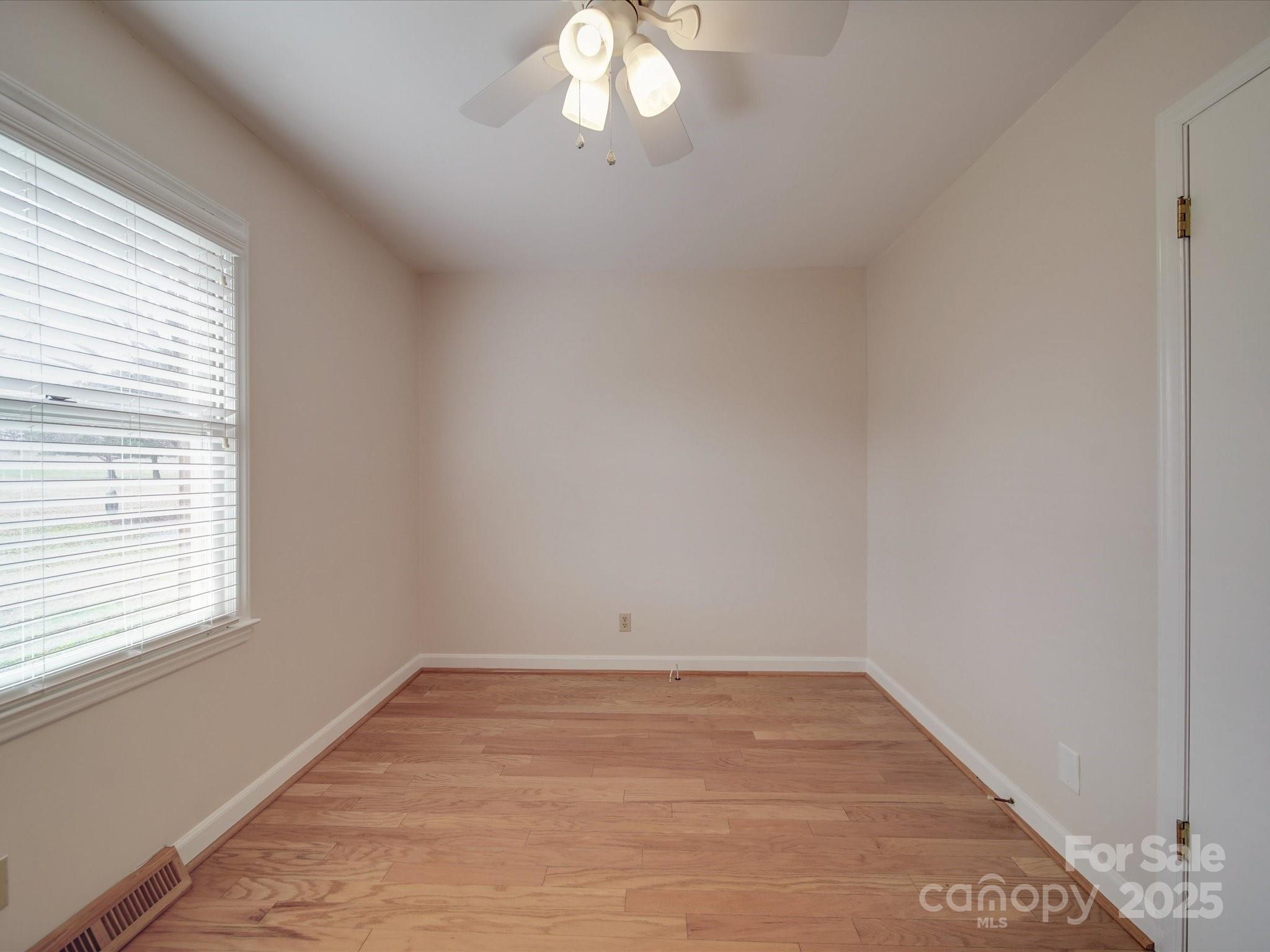 1515 Hasty Road Marshville, NC 28103 - Photo 32 of 40 wooden floor in an empty room with a window