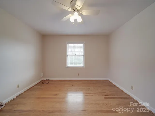 a view of an empty room with a fan