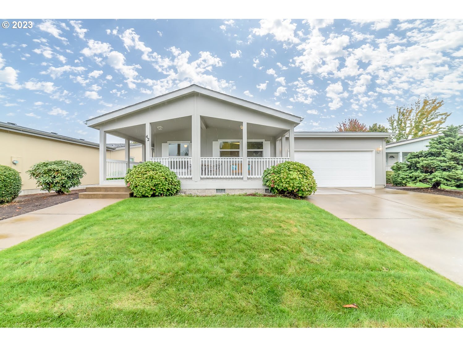 3220 Crescent Avenue, Unit 42 Eugene, OR 97408 - Photo 1 of 31 a front view of a house with a yard and garage