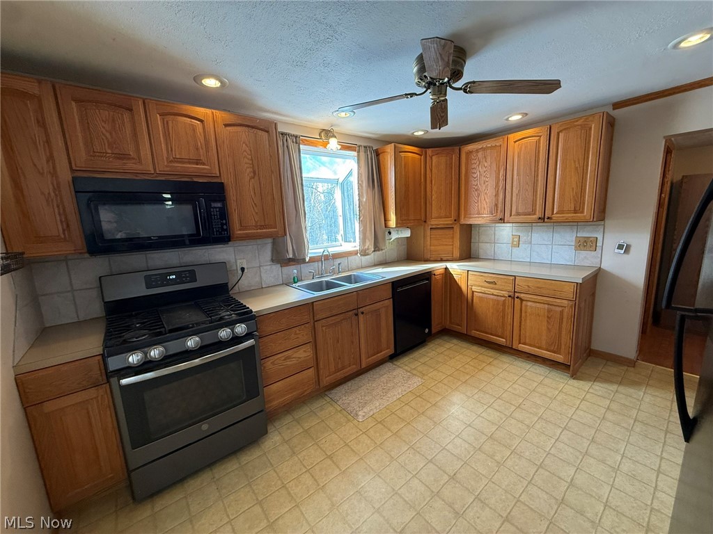 6784 Old Zoarville Road Northeast Dover, OH 44622 - Photo 10 of 50 Kitchen featuring black appliances, light countertops, wood finish cabinets, a ceiling fan, and recessed lighting