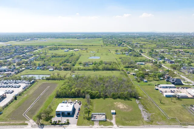 an aerial view of residential houses with outdoor space and river