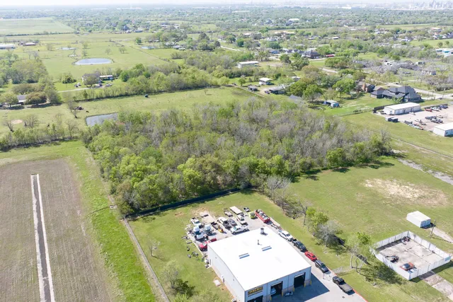 an aerial view of a residential houses with outdoor space