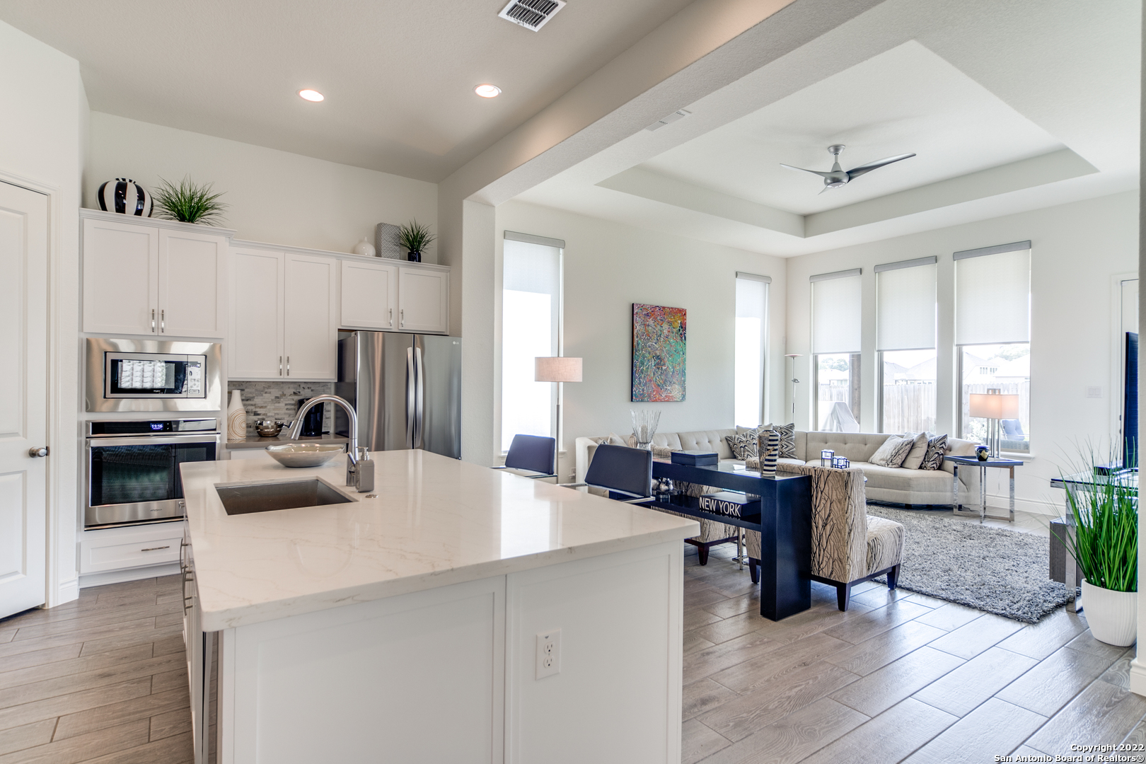 29734 Elkhorn Ridge Boerne, TX 78015 - Photo 12 of 25 a kitchen with sink a refrigerator and couches