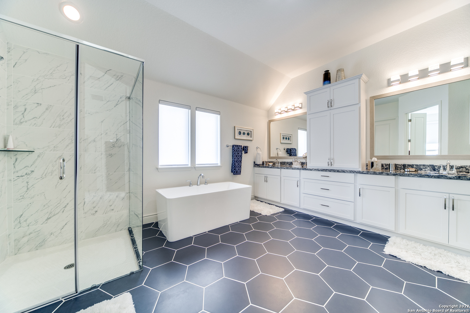 29734 Elkhorn Ridge Boerne, TX 78015 - Photo 19 of 25 a large bathroom with a double vanity sink mirror and a bath tub