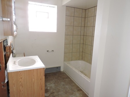 912 Madison Street Maywood, IL 60153 - Photo 15 of 23 a bathroom with a white bath tub and a sink