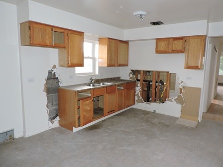 912 Madison Street Maywood, IL 60153 - Photo 17 of 23 a kitchen with stainless steel appliances granite countertop a stove a sink and a microwave