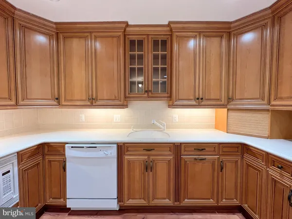a kitchen with granite countertop wooden cabinets and a sink