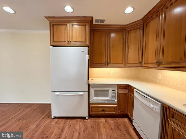 a kitchen with a refrigerator and a sink