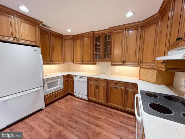 a kitchen with stainless steel appliances granite countertop a refrigerator sink and cabinets