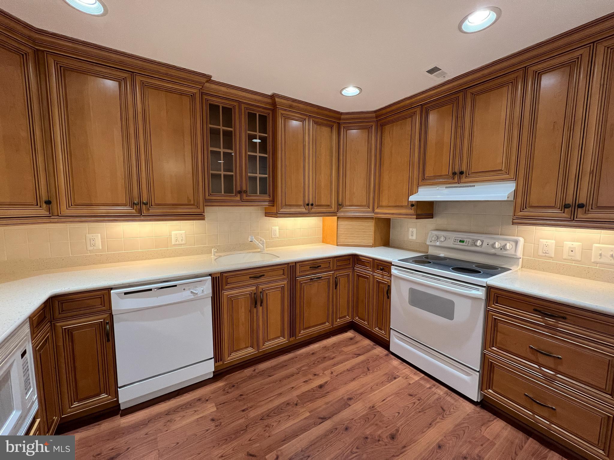 3163 Adderley Court Silver Spring, MD 20906 - Photo 17 of 26 a kitchen with granite countertop wooden cabinets a sink and dishwasher