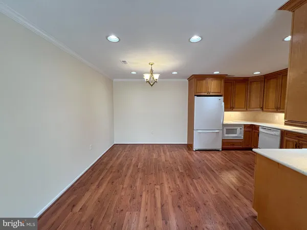 a view of kitchen with wooden floor electronic appliances and window