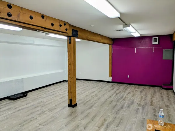 a view of a room with wooden floor